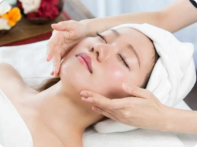 Person laying down relaxing getting a facial treatment