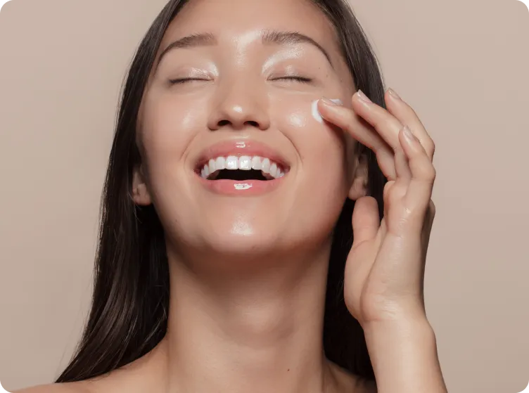 Person putting a cream on their face